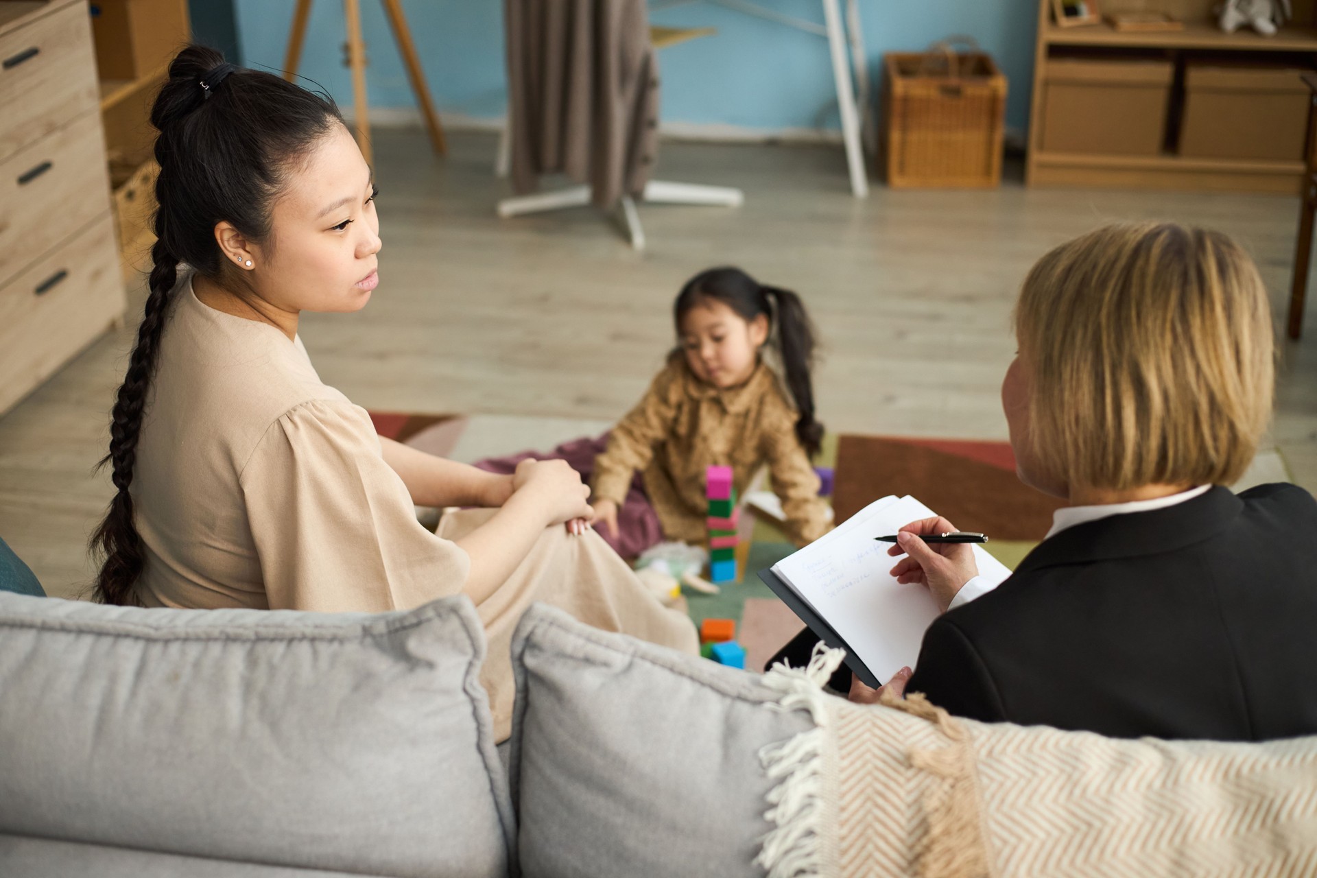 Attending Family Therapy Session with Child Playing